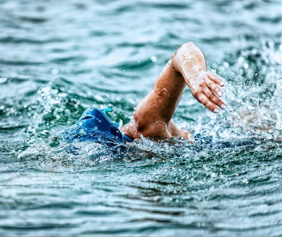 A swimmer glides through the open water, showcasing one of the exciting outdoor activities in Mooloolaba. Discover more Mooloolaba things to do, from ocean swims to beachside adventures.