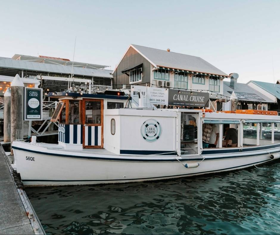A scenic Mooloolaba Canal Cruise boat docked at Mooloolaba Wharf, offering one of the top Mooloolaba things to do, with relaxing river views and waterfront dining nearby.