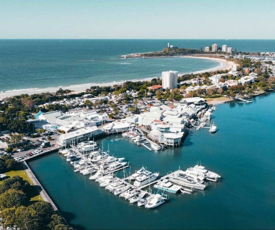 A stunning aerial view of Mooloolaba Wharf, showcasing its vibrant waterfront dining, luxury yachts, and prime location along the Sunshine Coast.